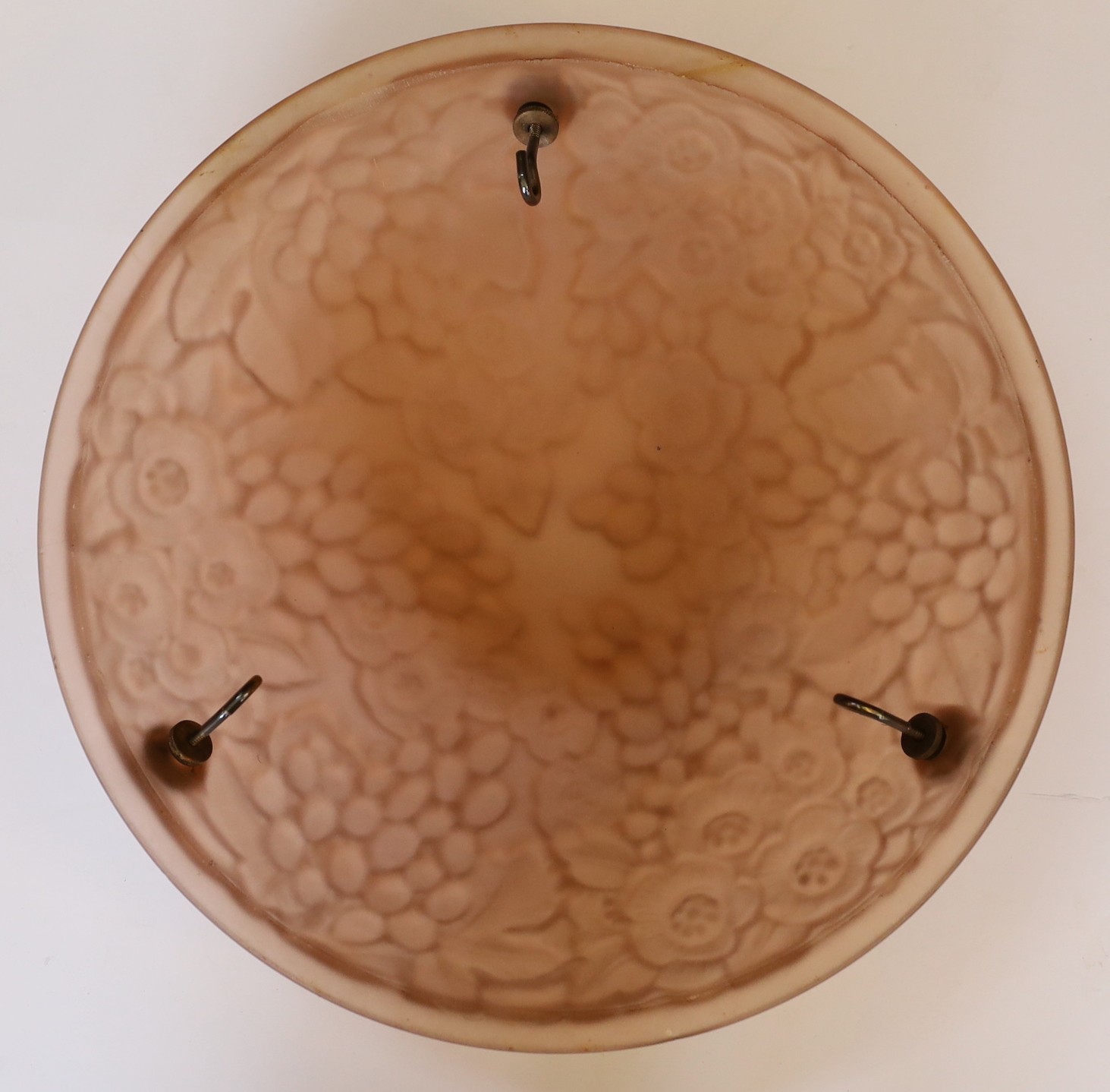 A 1920s-30s French amber glass light bowl moulded with flowers and grapes, with chain set and ceiling rose, diameter 35cm